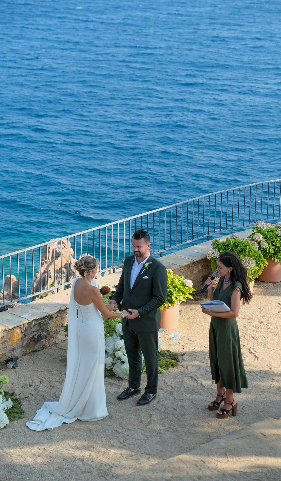 Photo of couple with sea backdrop getting married at El Convent De Blanes with Madison The Celebrant