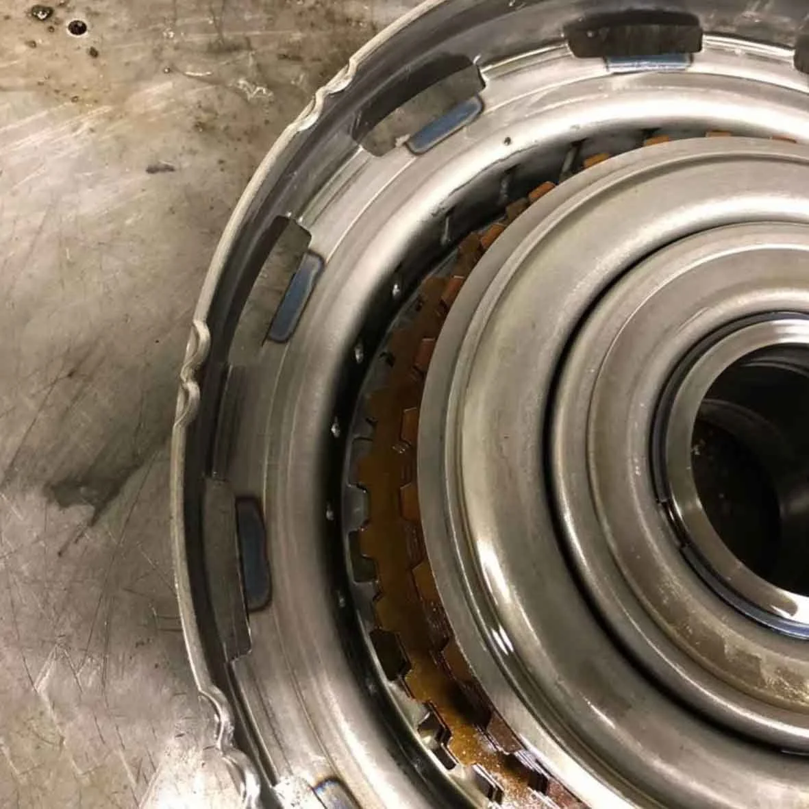 Close-up of a large mechanical bearing or gear assembly, showing metal components and internal gears.