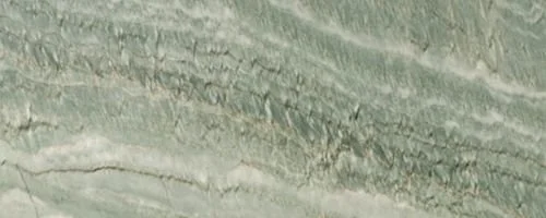 Close-up of a textured green and beige surface, possibly stone or mineral.