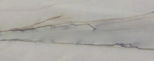 Close-up of a marble surface with light veins and subtle color variations.