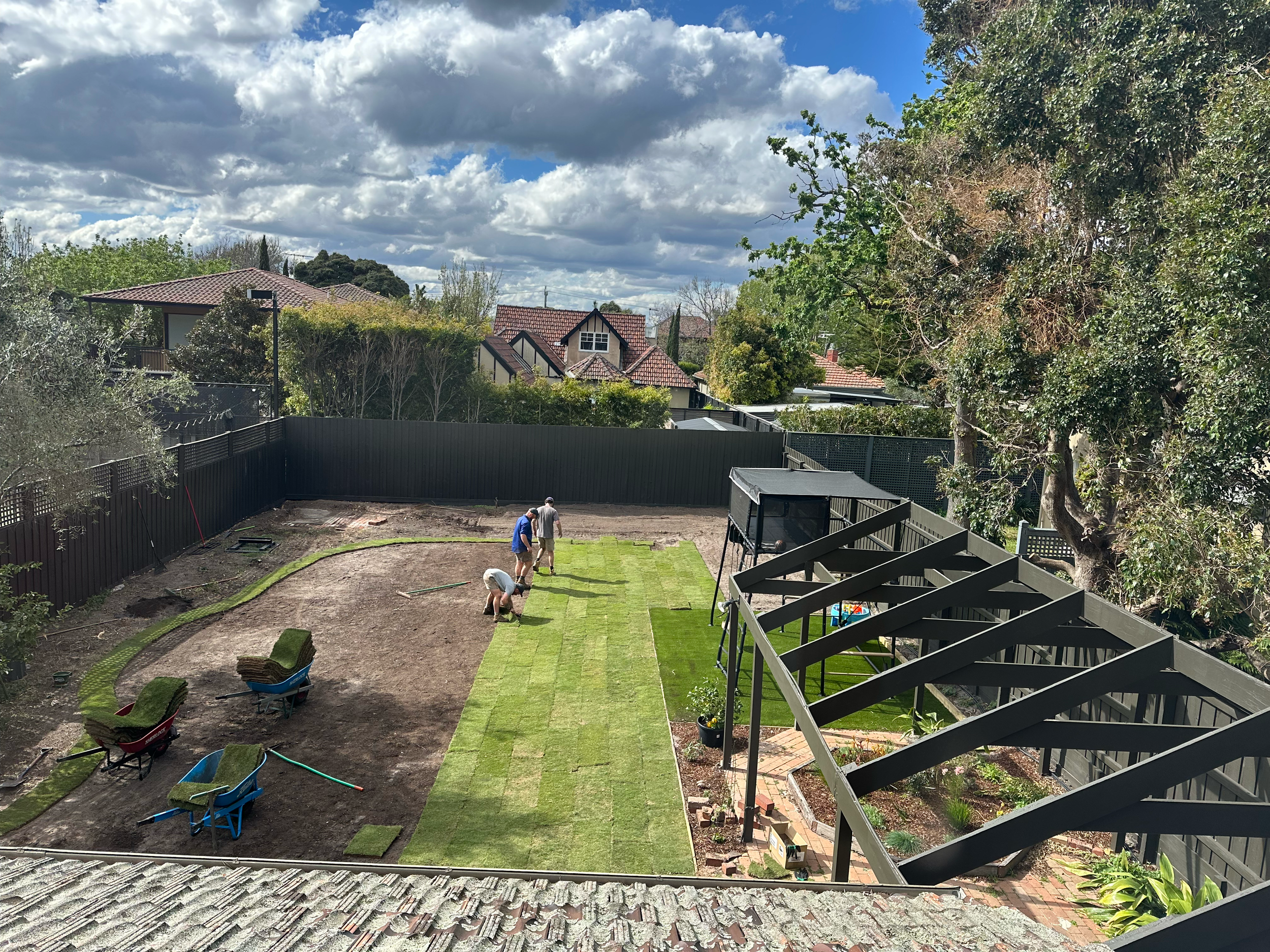 Isometric view of the team laying down 185m2 of TifTuf Couch at a client's property in Sandringham.