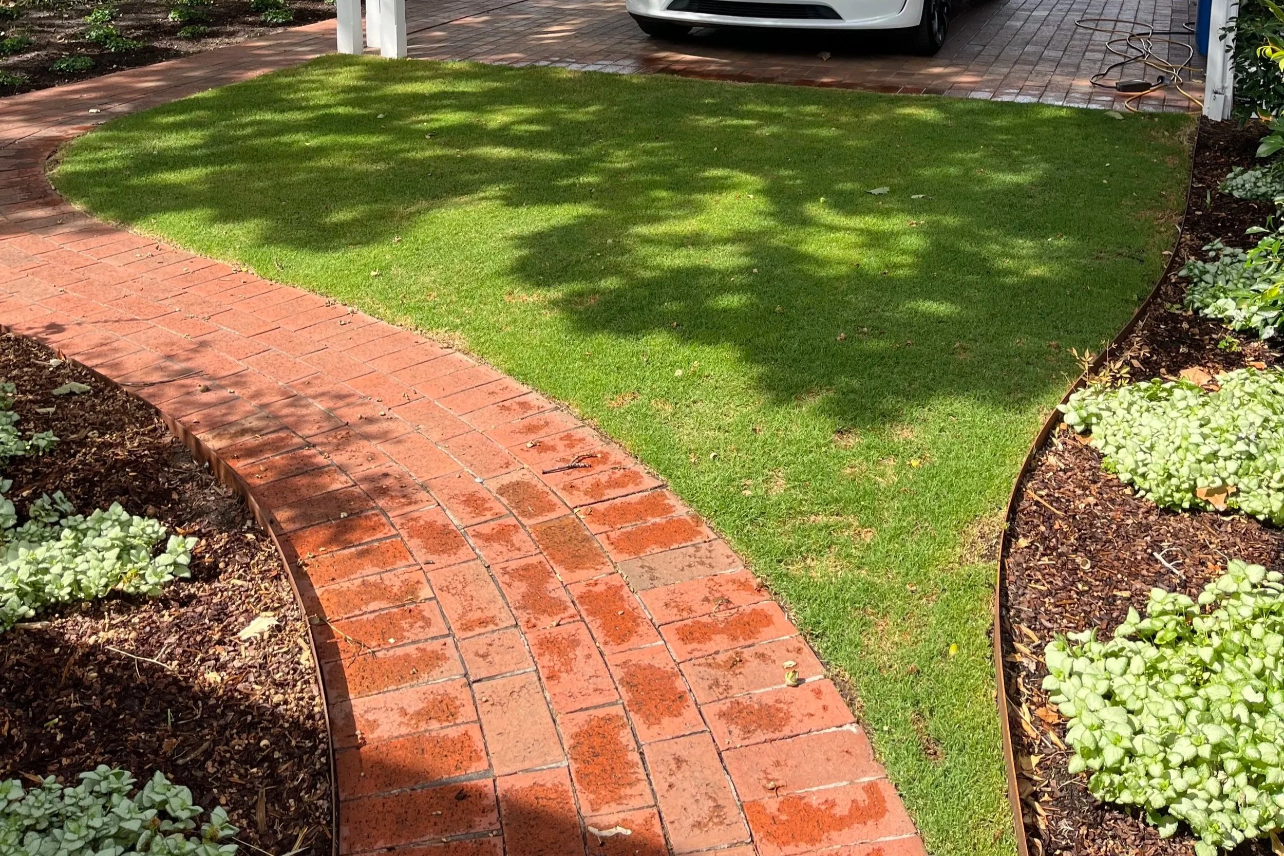 Healthy lawn under a shaded carport