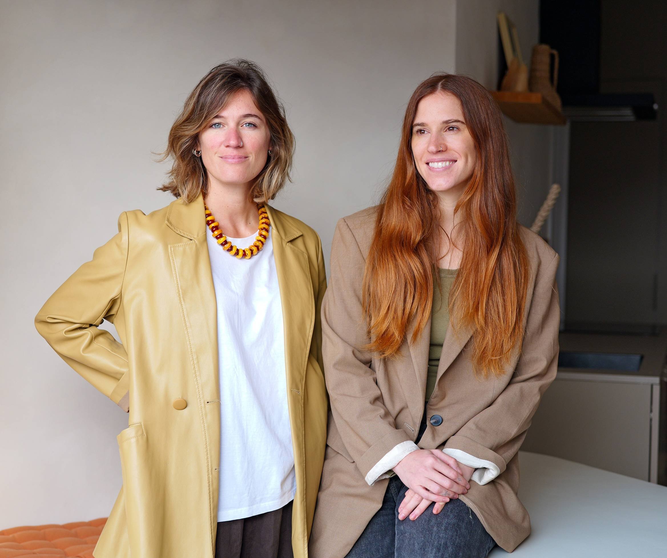 Two founders of The Flow, a human-centred HR consultancy, standing side by side in a calm studio setting.