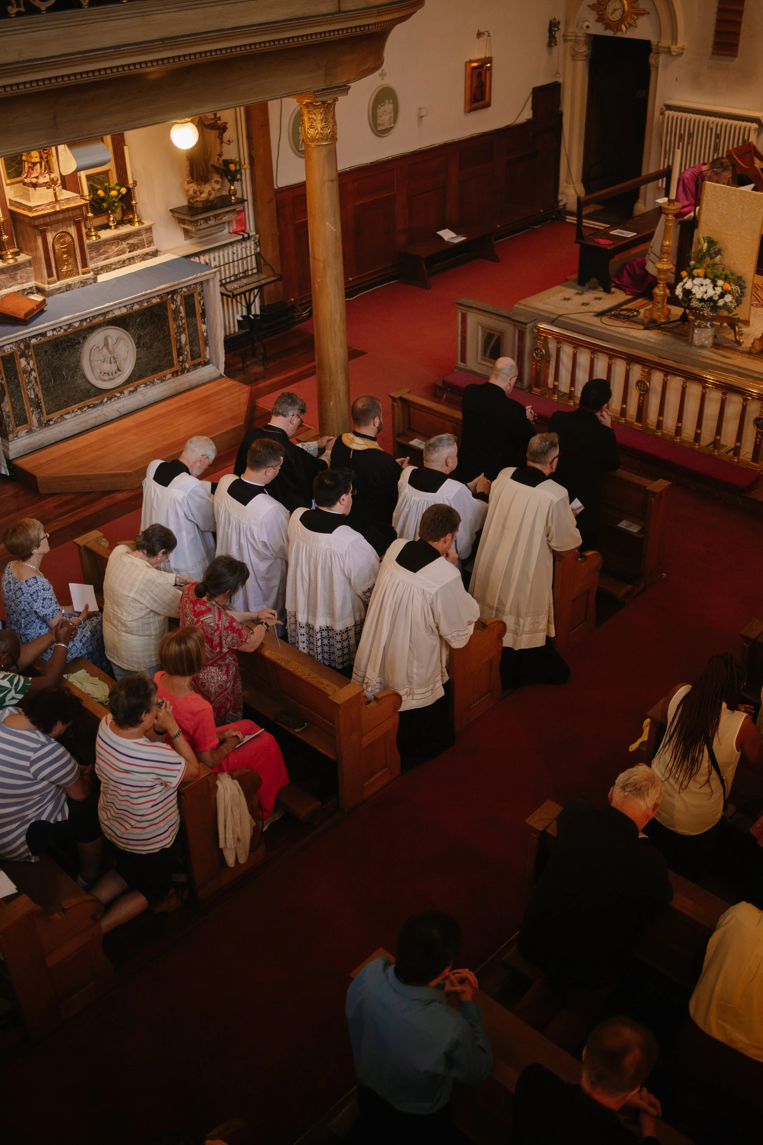 People praying inside a church during a mass.