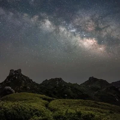 Night sky with the Milky Way above mountains representing the soul’s life path and natal chart.