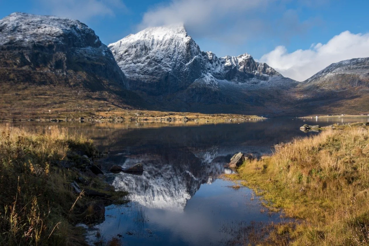 Mountain landscape reflected in still water symbolising past life memory and soul continuity.