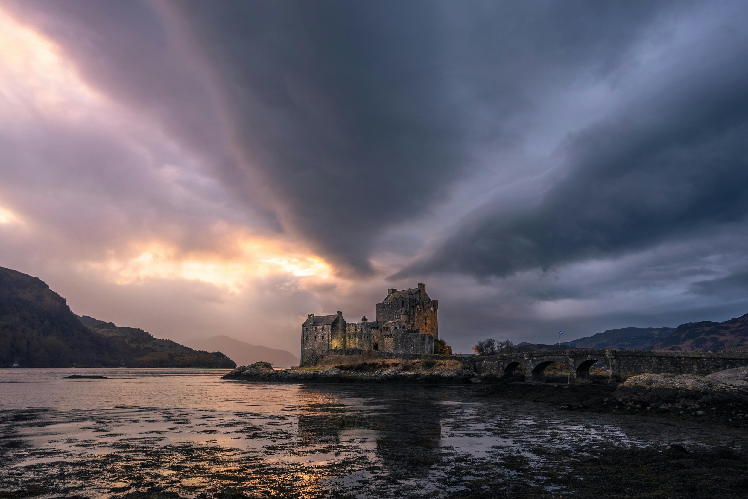 Ancient stone castle beneath dramatic skies, symbolising karmic history, soul memory, and past life themes in astrology.