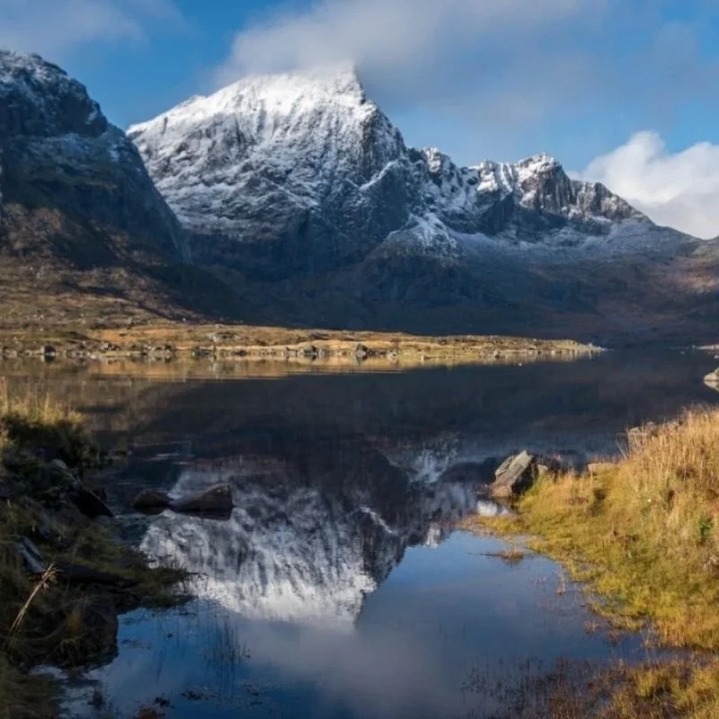 Mountain landscape reflected in still water symbolising past life memory and soul continuity.