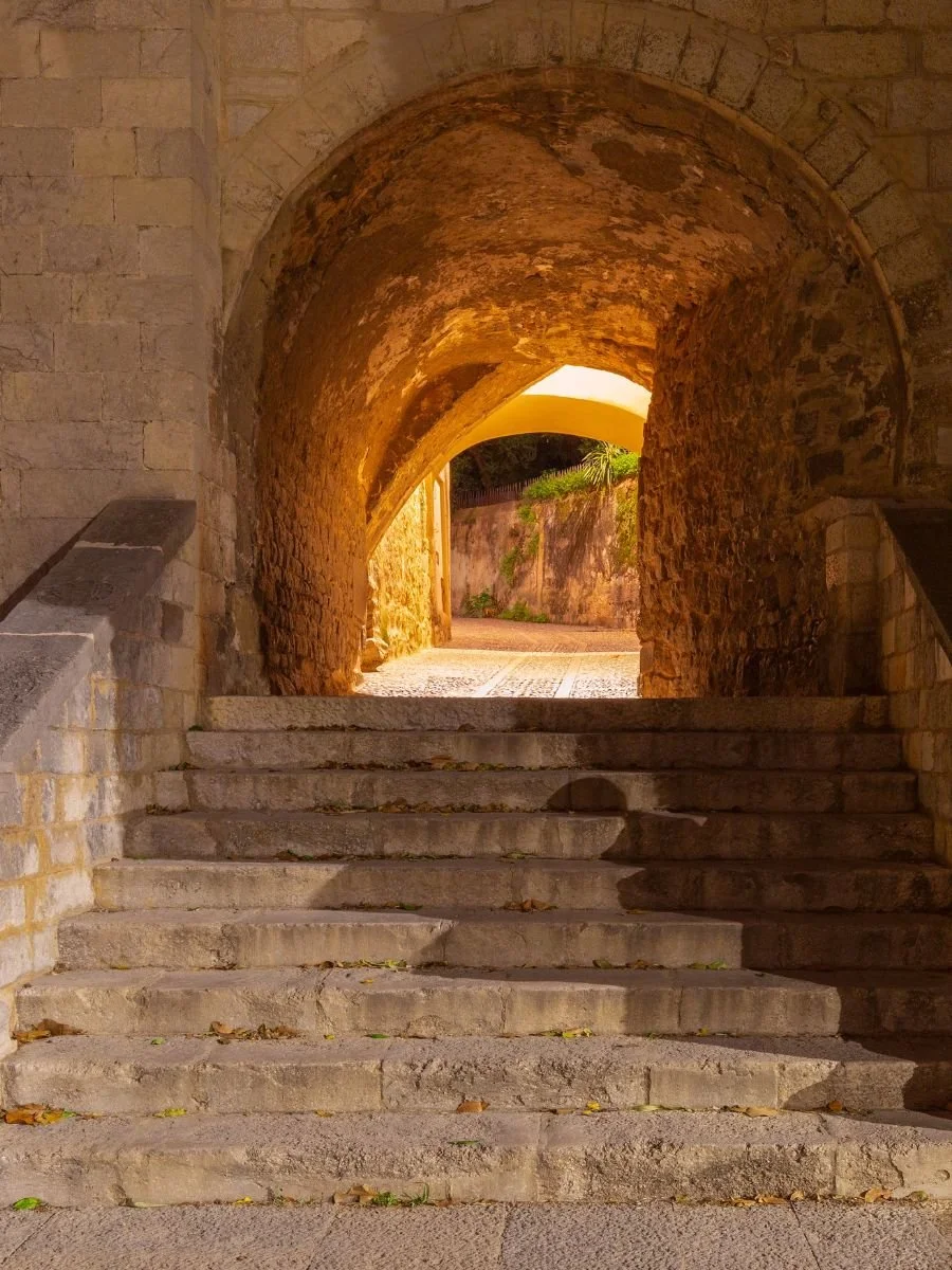 Stone steps leading through an arched passage representing initiatory transits of maturity and awakening in Evolutionary Astrology