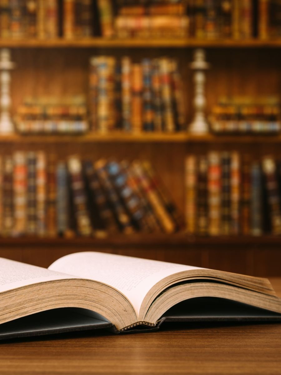 Open book in a library representing the foundations of transits in Evolutionary Astrology and learning to read time consciously