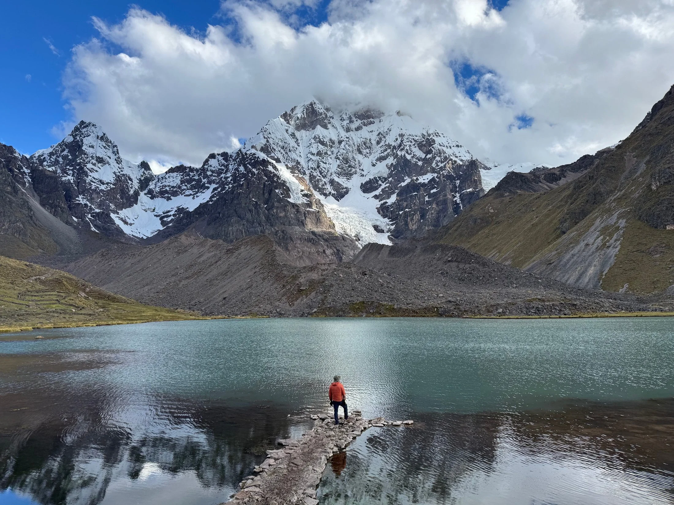 “Snow covered mountains and turquoise lake in Peru during a Huachuma and Karpay retreat”