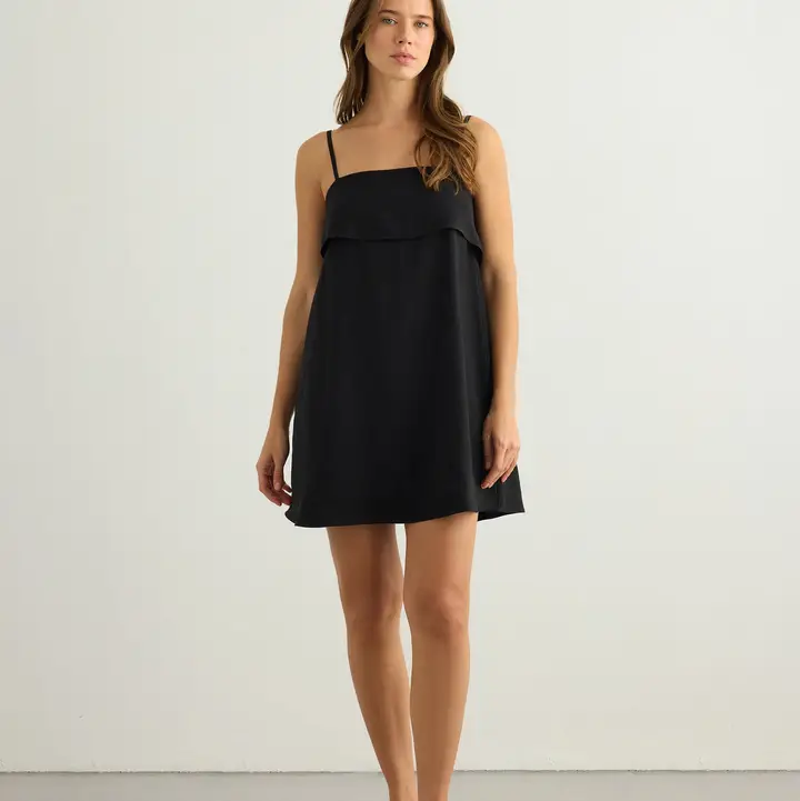 Full-length back view black mini dress.png