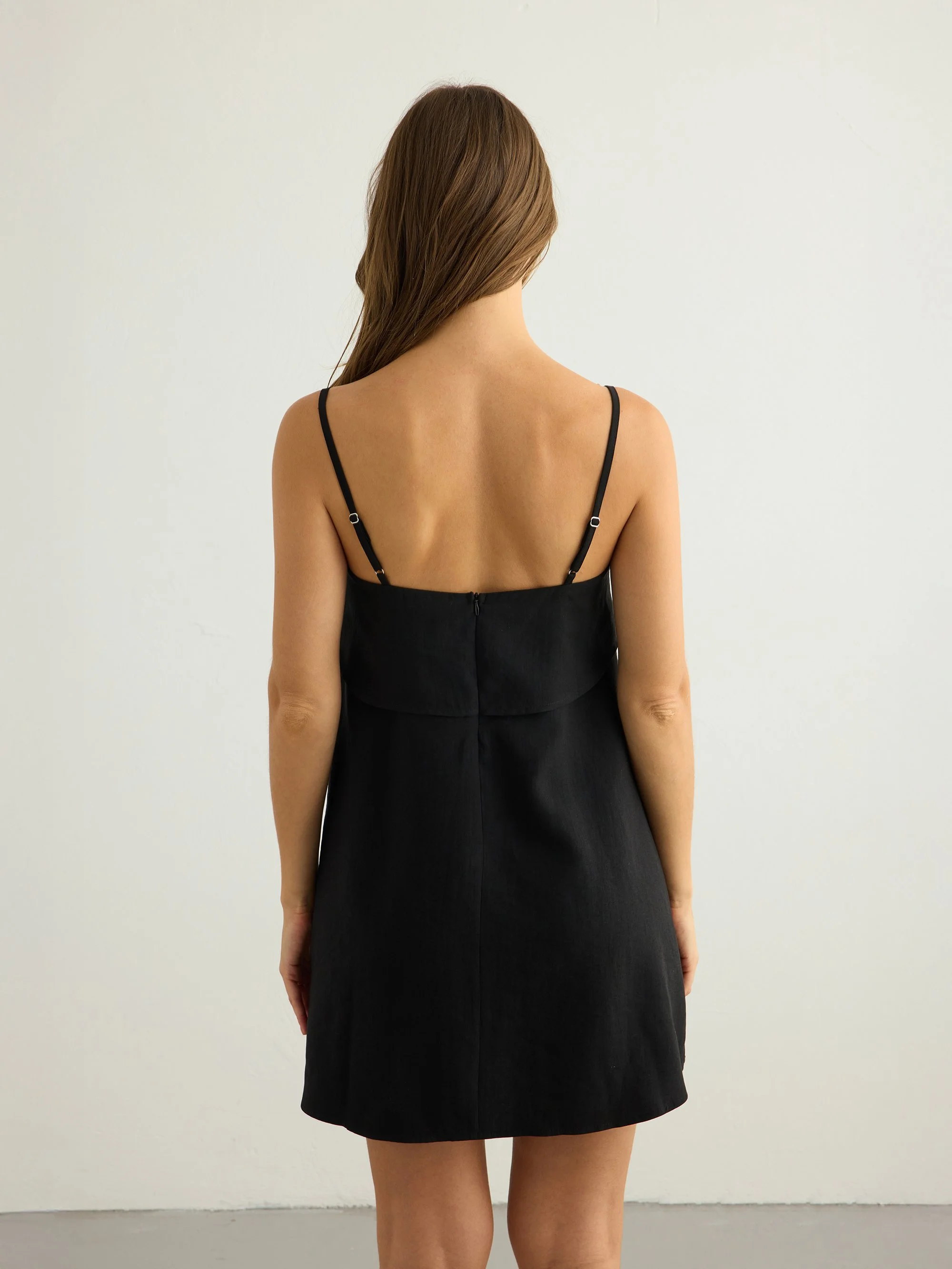 Back view of black mini dress with adjustable straps.jpg