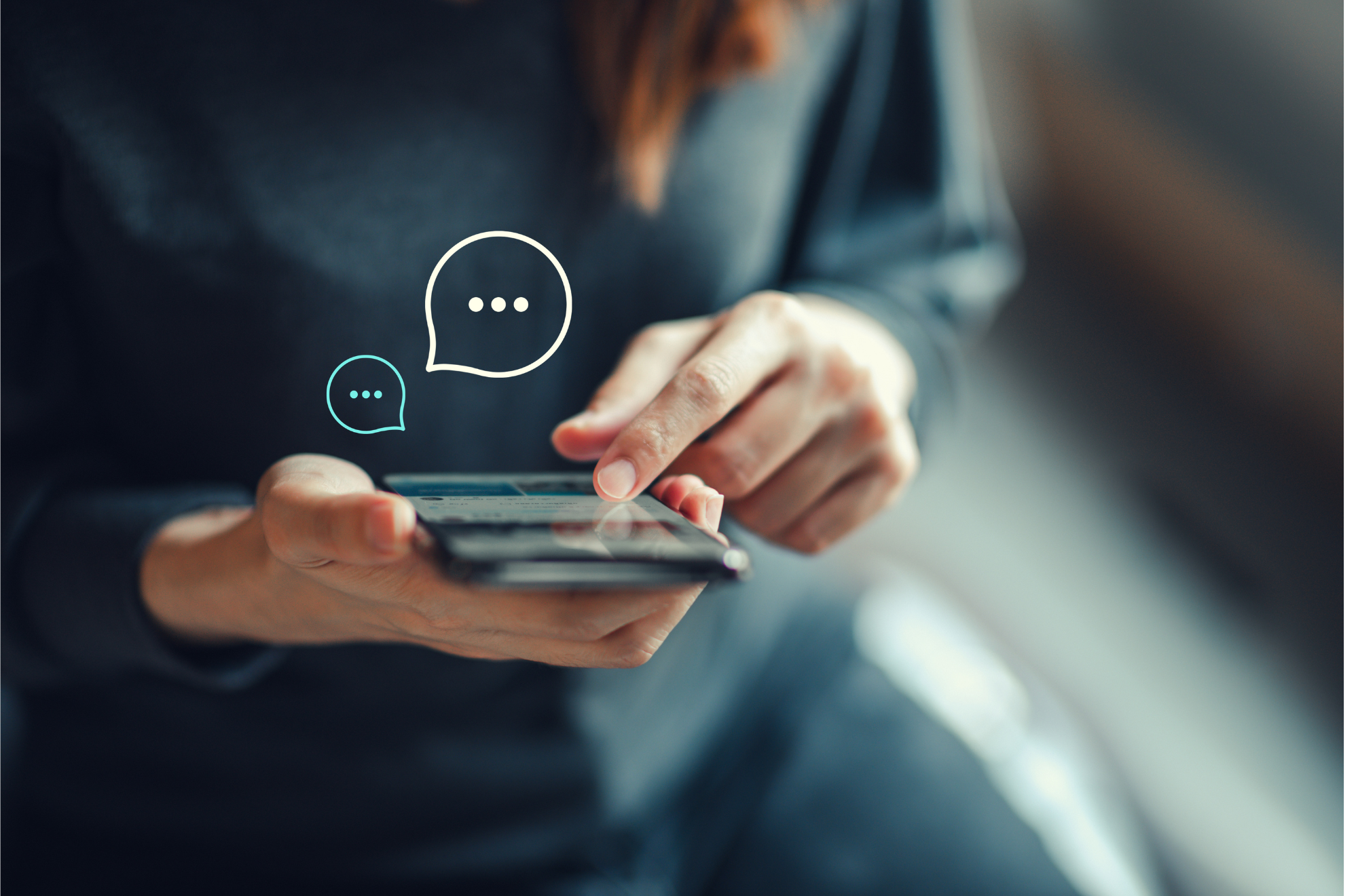 Person in a dark blazer using a smartphone with chat bubbles graphic overlaid.