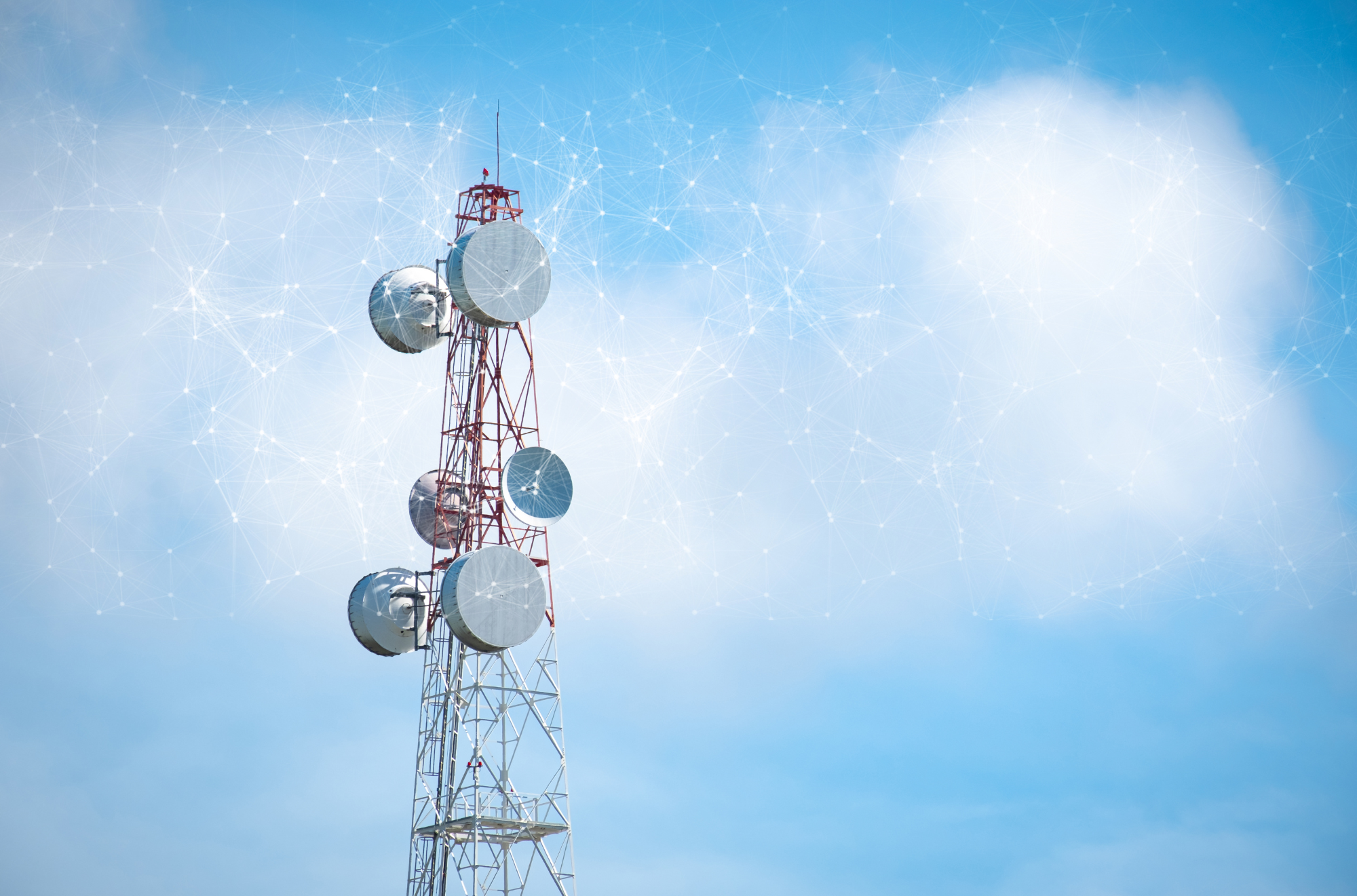 A tall communication tower with large satellite dishes set against a blue sky with a digital network overlay.