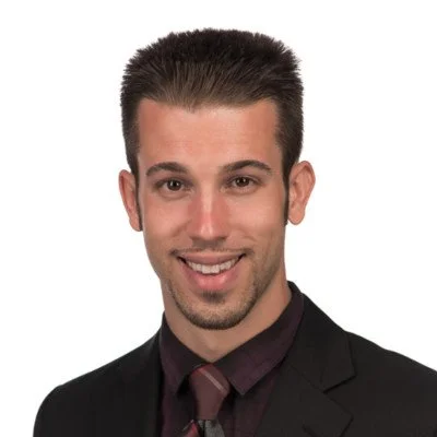A professional headshot of Jordan Dice, President and CEO of IPtelX.