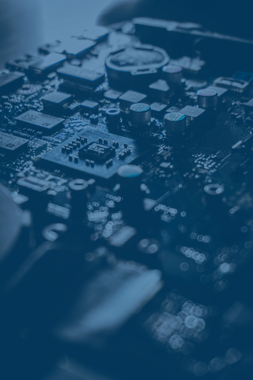 Close-up of a computer motherboard with various electronic components such as capacitors, chips, and connectors, shown in a blue tint.