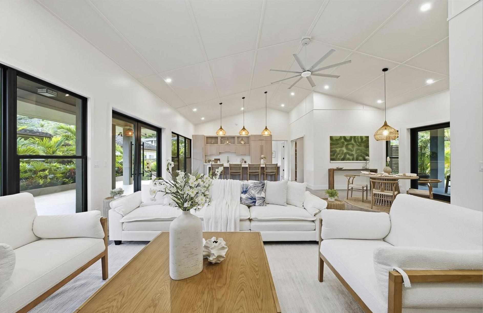 Luxury real estate interior photography in Dubai featuring a modern open plan living room with high ceiling, natural light, premium finishes