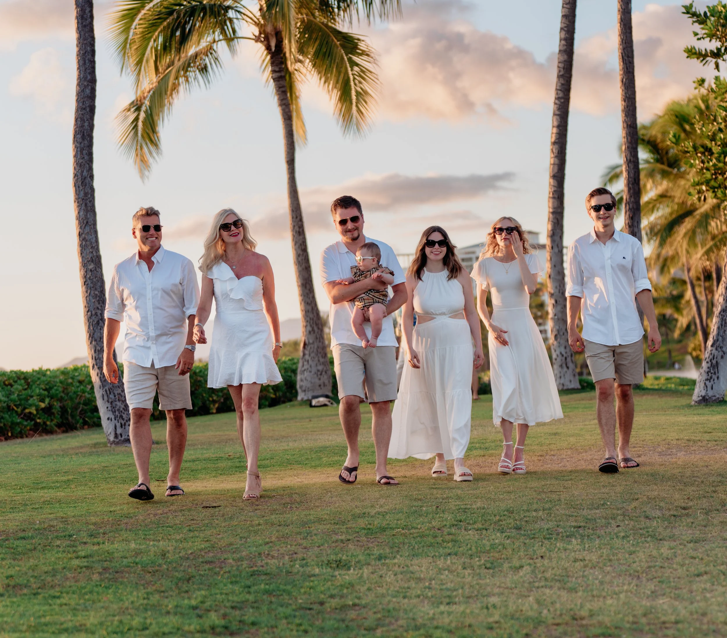 Family walking together on the beach during a sunset photoshoot-relaxed and candid family portrait session captured by Natalya Vladi.