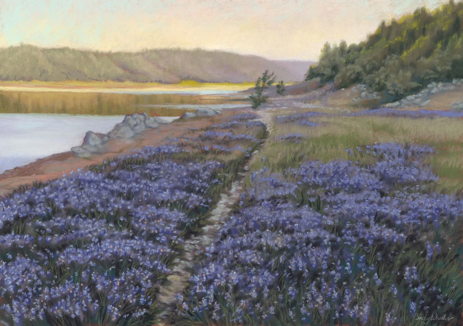 A landscape painting of purple flowers in the foreground, a narrow dirt path, a body of water, and rolling hills and trees in the background during sunset.