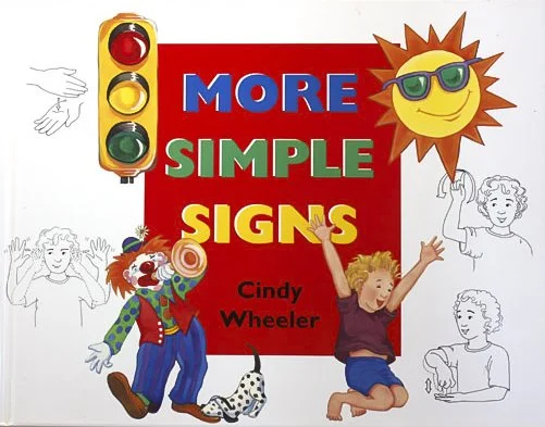 Book cover titled 'More Simple Sign's' by Cindy Wheeler, featuring a colorful comedy clown, a smiling sun with sunglasses, and children, with some illustrations in black and white