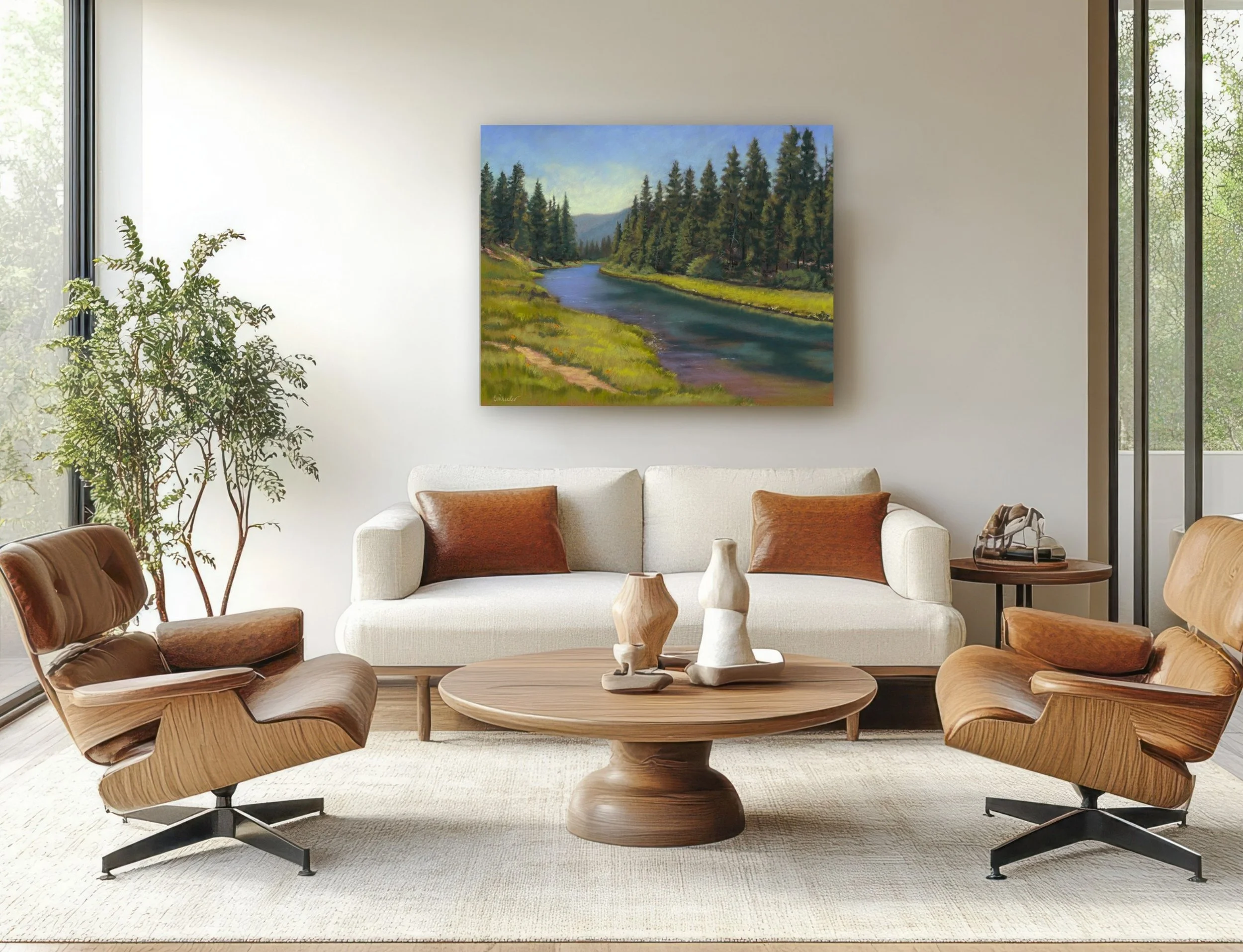 Living room with two brown armchairs, a white sofa with brown pillows, round wooden coffee table with decorative vases, a tall green plant, and a landscape painting of a river and trees on the wall. Large windows on the sides let in natural light.