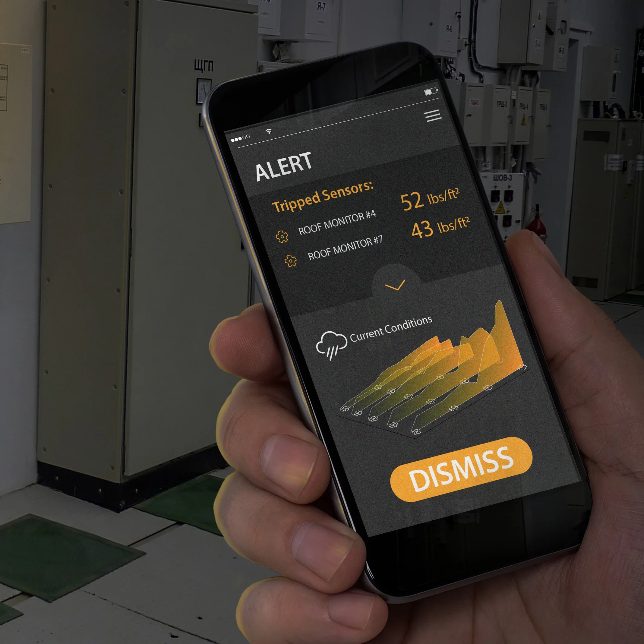 Hand holding a phone displaying a roof monitoring app