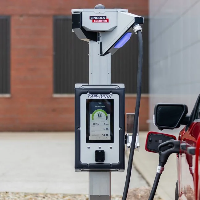 EV charging pedestal charging a red truck