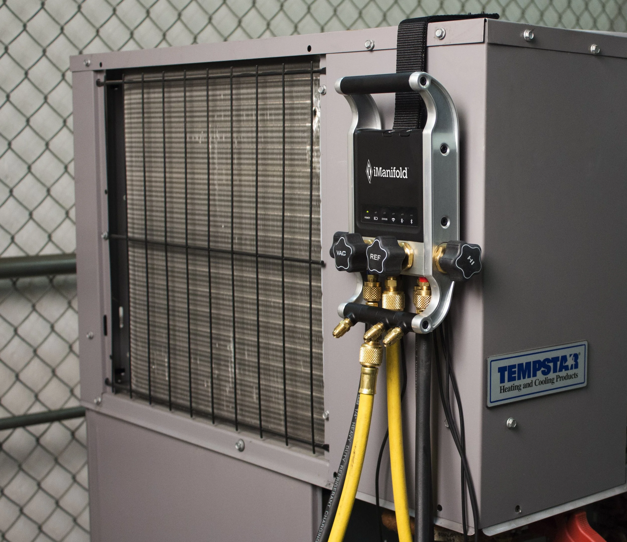 HVAC tool hanging on the side of an outdoor AC unit