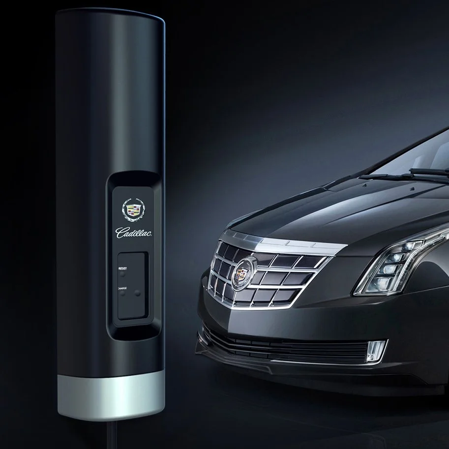 Cadillac EV wall charger on a dark black background with the car behind it