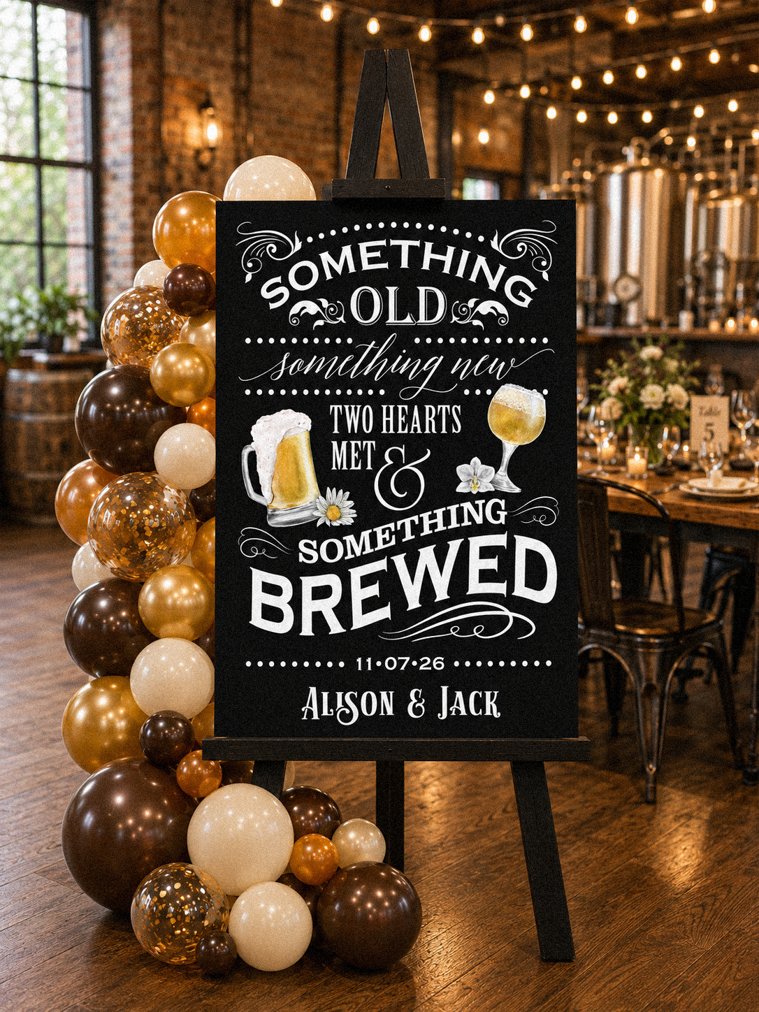 A rehearsal dinner entry easel with a personalized sign that reads "Something old, something new, two hearts met and something brewed" adorned with a balloon garland in a brewery venue