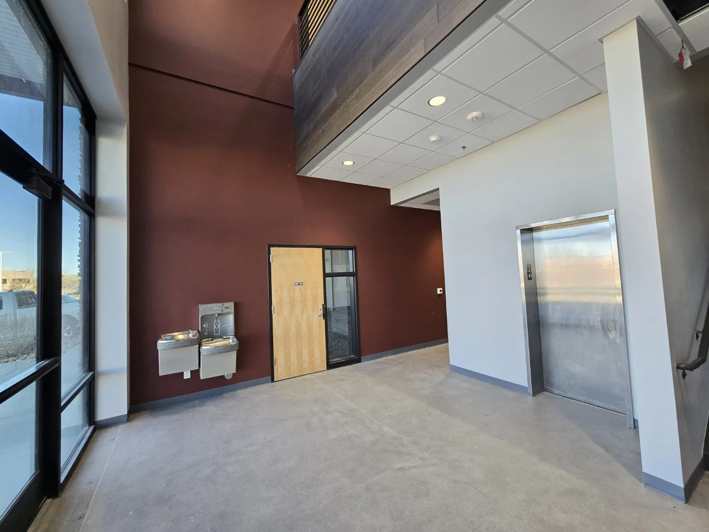 Finished lobby common area at Own It Vista flex office warehouse condos in Lafayette Colorado with elevator access and shared building amenities.