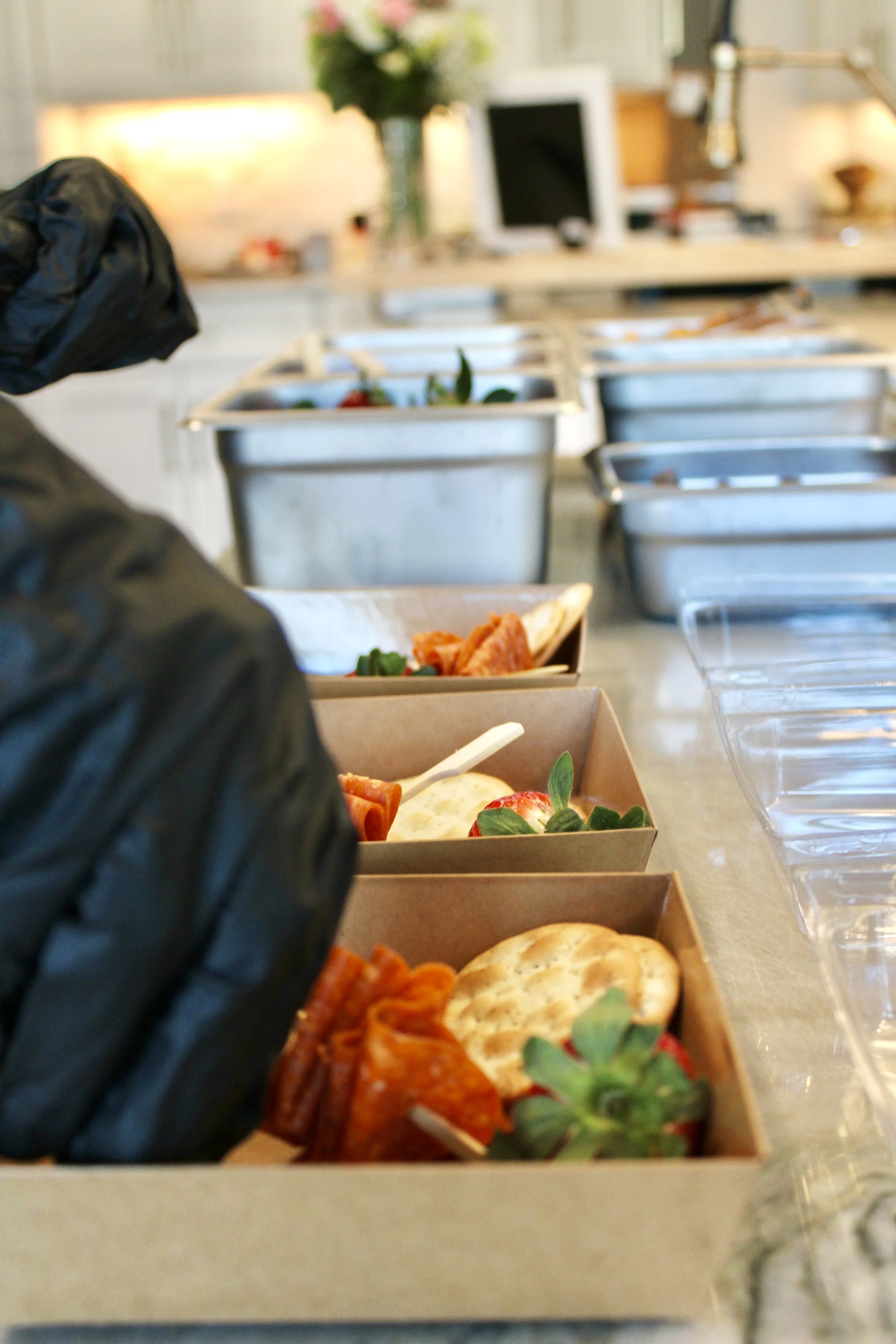 to-go charcuterie boxes including crackers, strawberries, and cheese for a corporate luncheon from The Charcuterie Chics near High Point NC