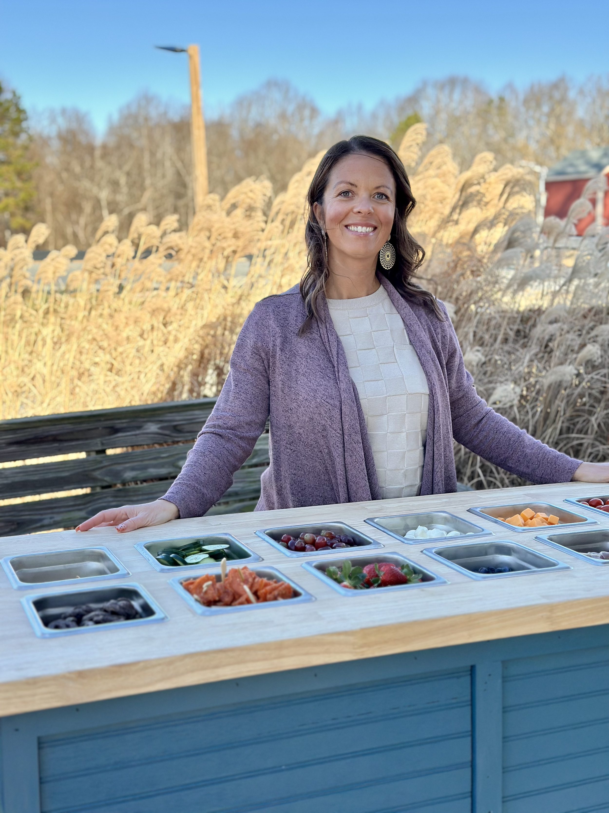 Amber standing near her mobile charcuterie cart near Huntersville NC