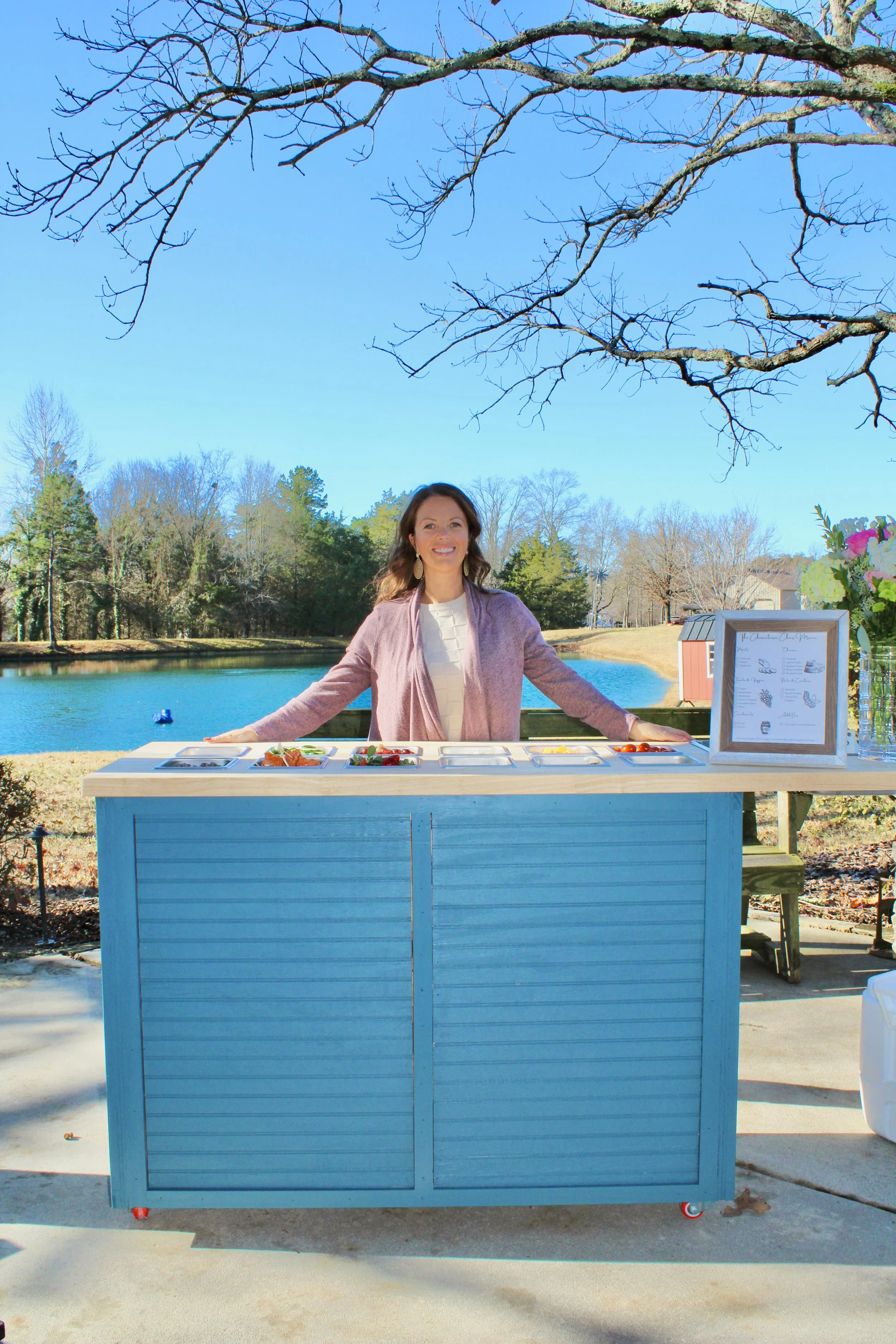 Amber standing by her mobile charcuterie cart from The Charcuterie Chics near Statesville NC