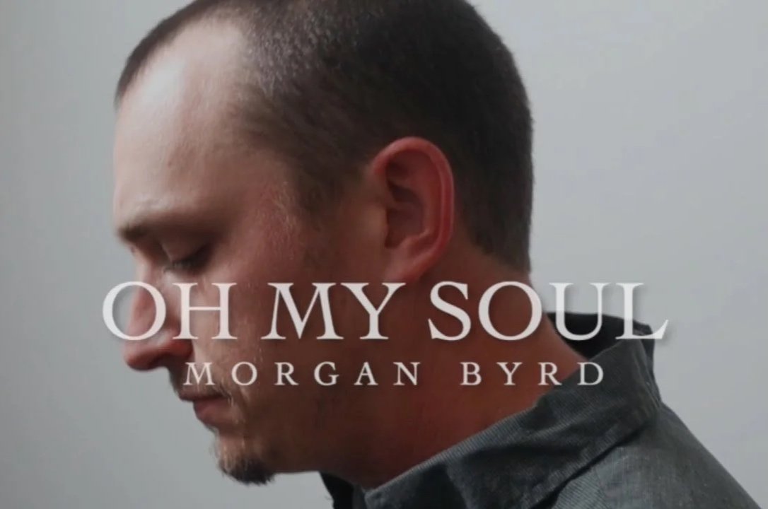 Close-up of a man with short dark hair and a beard looking downward, with text overlay reading "OH MY SOUL MORGAN BYRD".