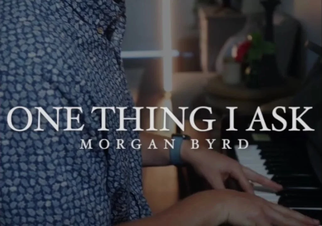 Person playing piano in a room, with text overlay reading 'One Thing I Ask' and 'Morgan Byrd'.