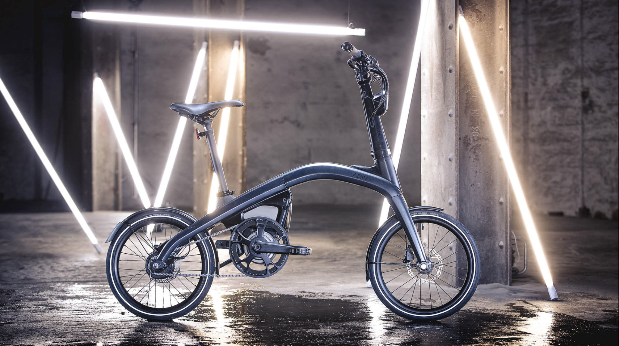 An electric bicycle in a futuristic, industrial setting with concrete walls and LED light fixtures.