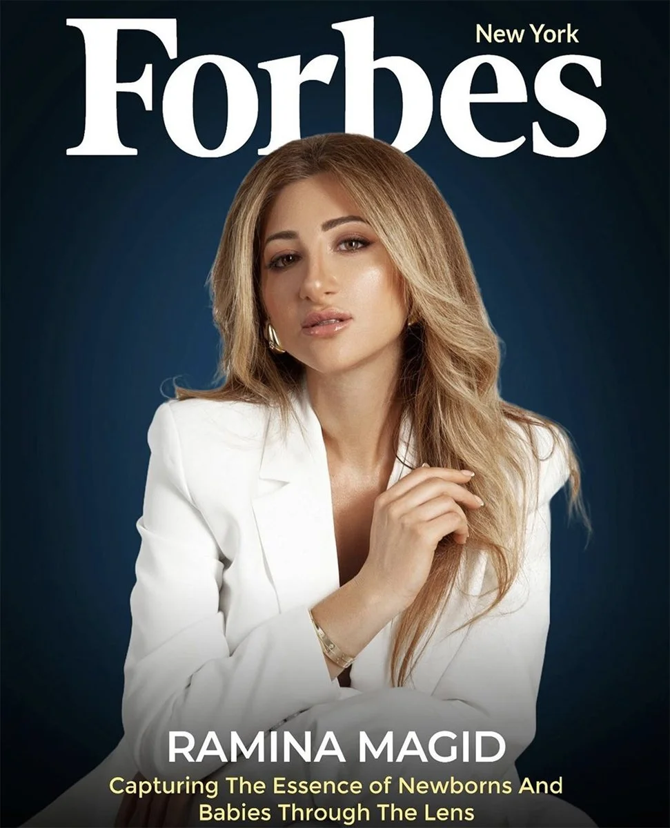 Forbes magazine cover featuring Ramina Magid with a lighting background, wearing a white suit and gold accessories, with the headline 'Capturing The Essence of Newborns And Babies Through The Lens'.