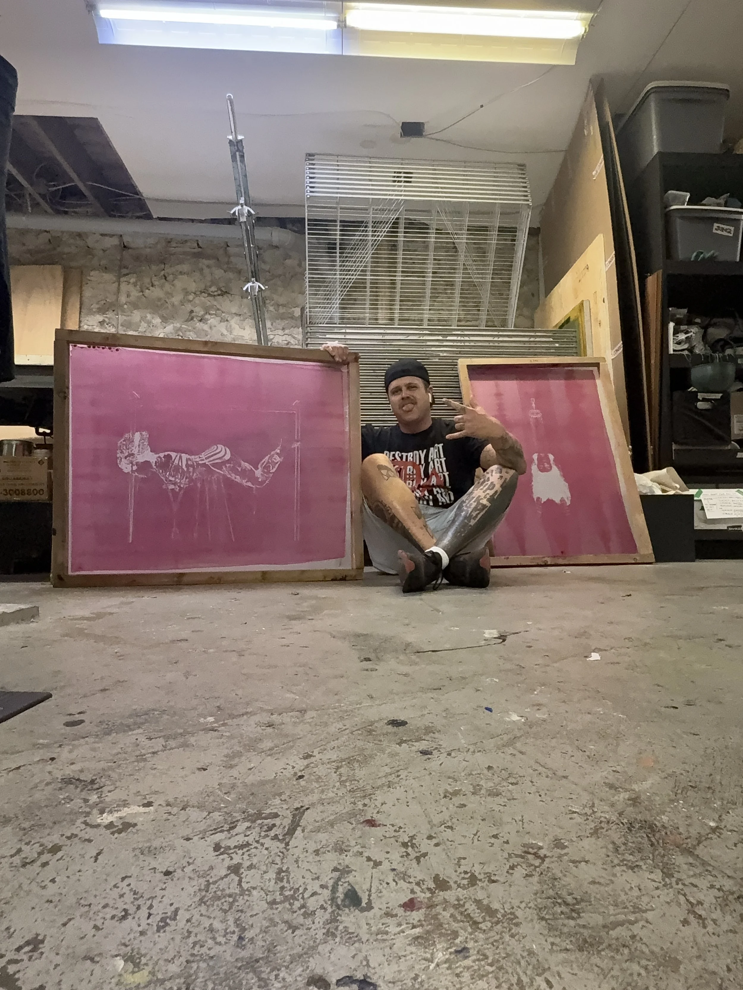 Self-Portrait with two of the large custom built screens I made to print the artwork for the "Bleed Like Me" Gallery Exhibit.
