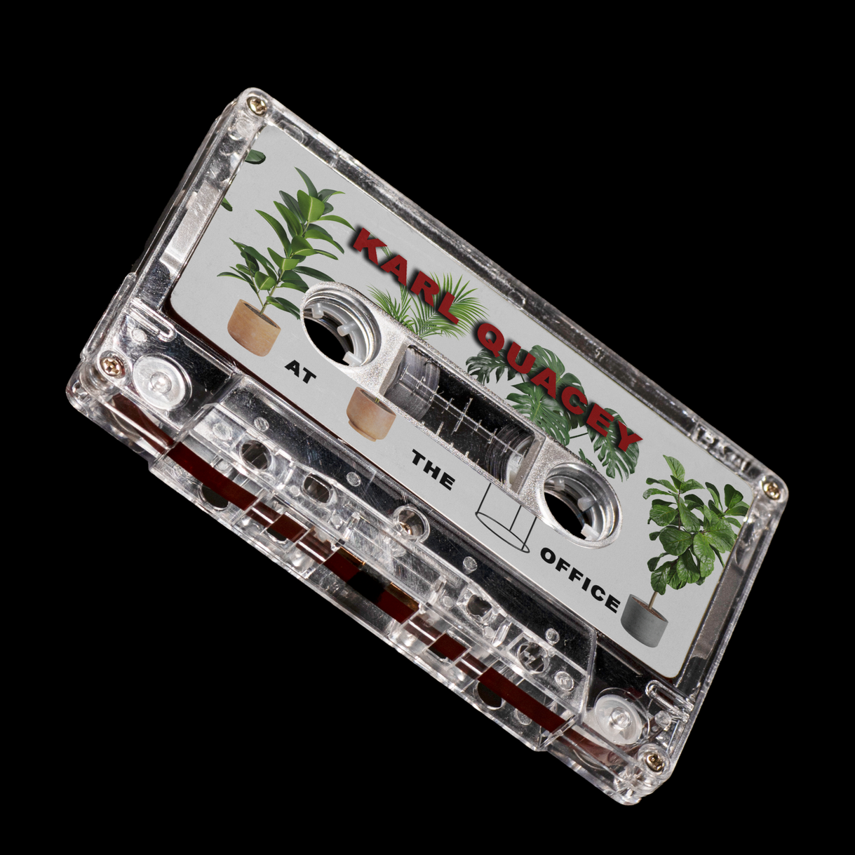 A cassette tape labeled 'Karl Quecy at the Office' with green potted plant illustrations on a black background.