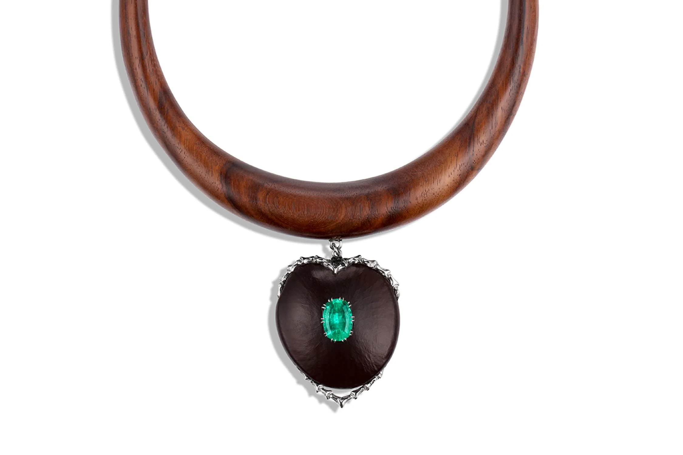 A wooden necklace with a pendant featuring a large dark stone, accented by a small green gemstone.