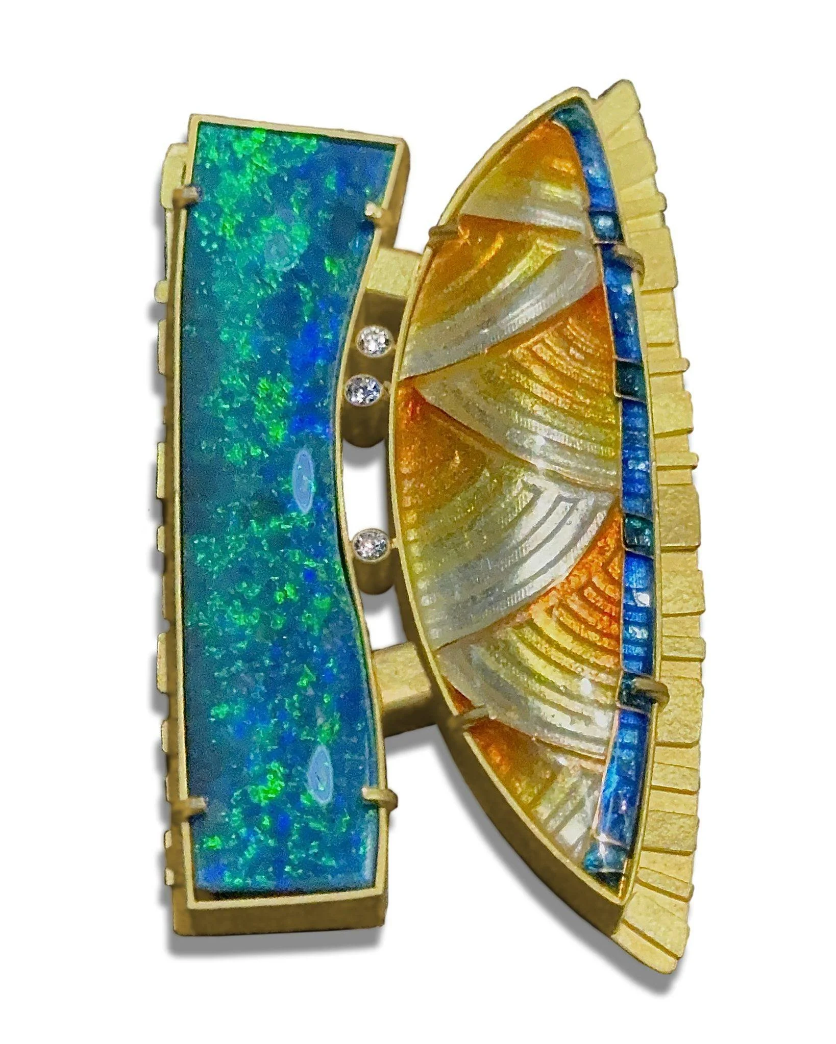 A close-up of a colorful, antique brooch with embedded opal and shell inlays, bordered with gold and featuring a row of small diamonds.