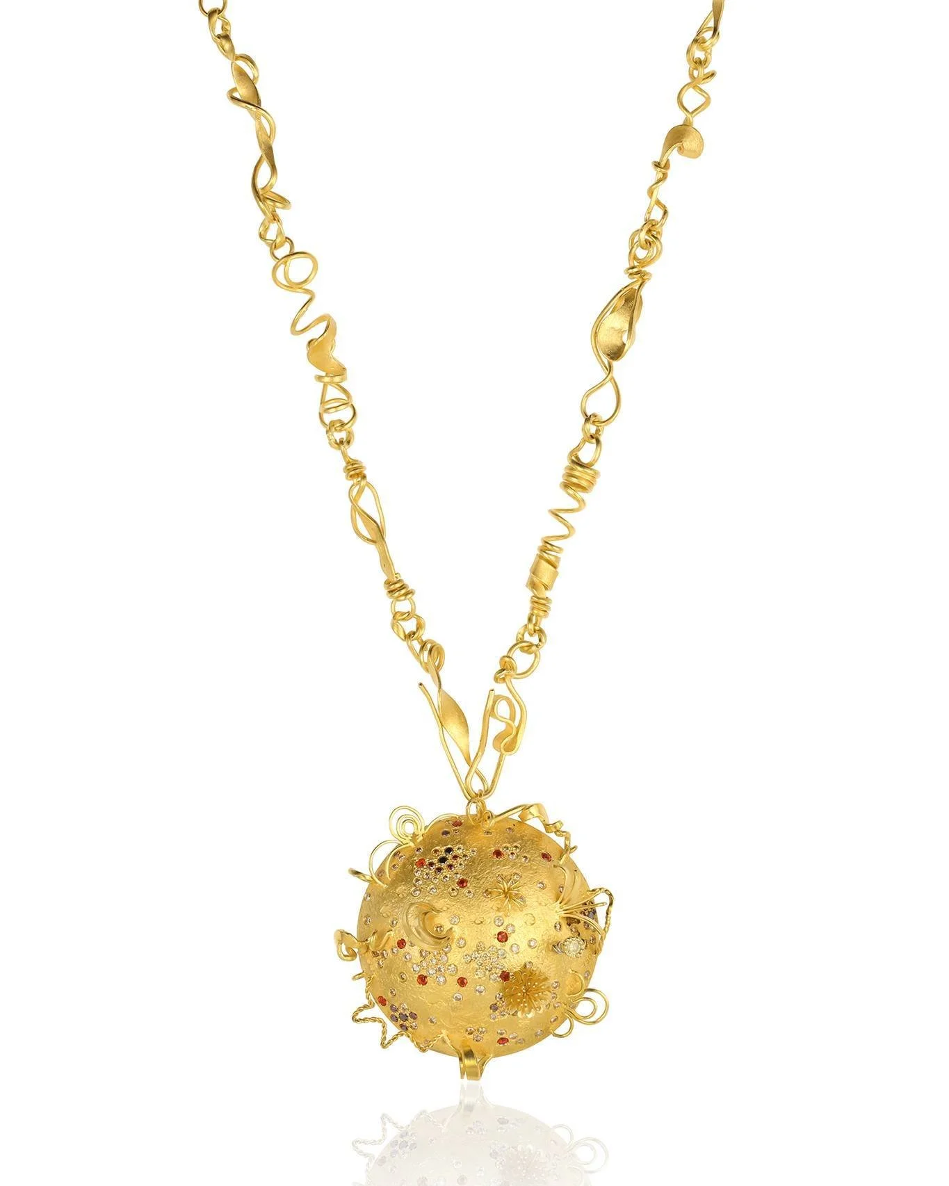 Gold necklace with a spherical pendant decorated with small red, white, and black gemstones, intricate floral and swirl designs.
