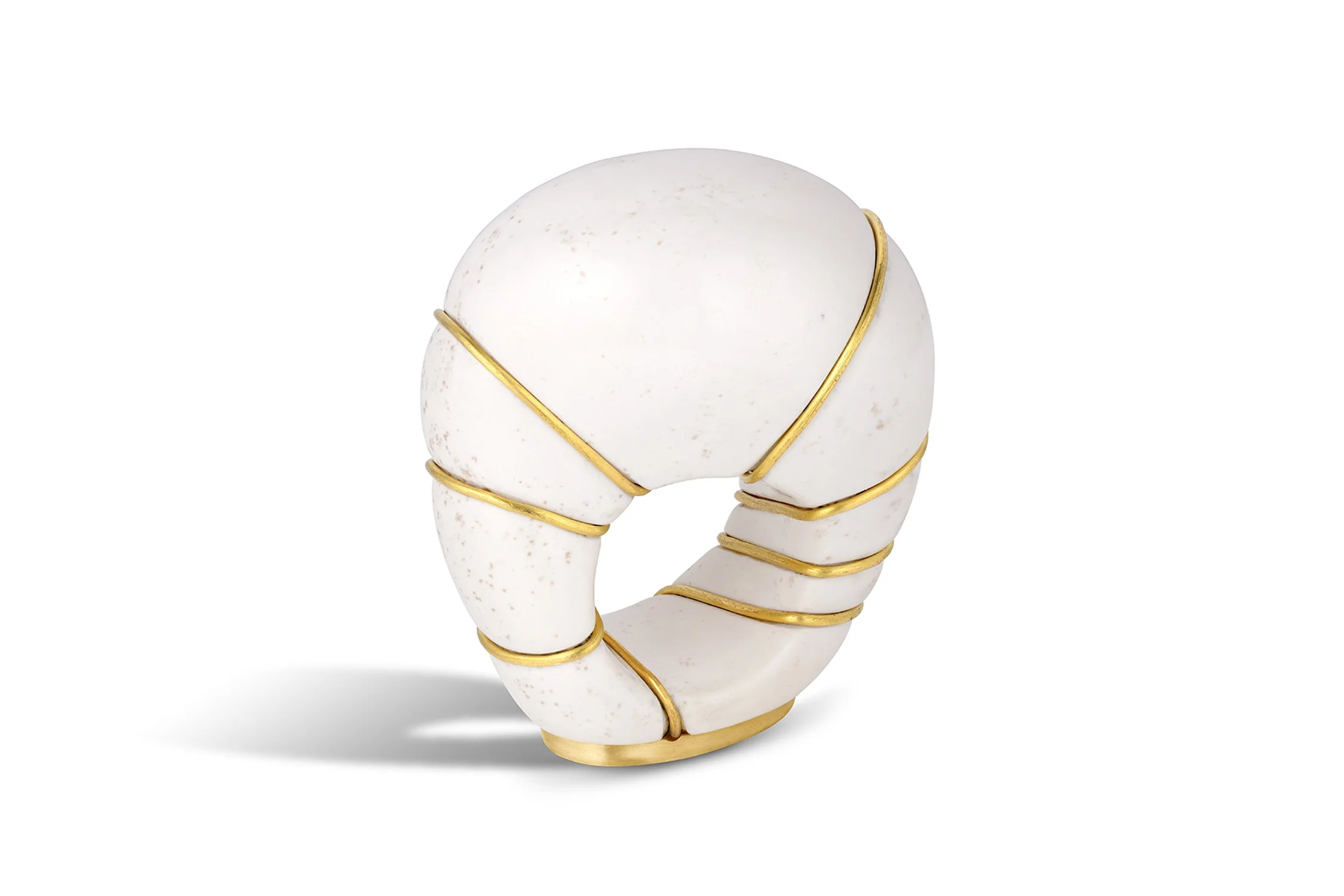 White ceramic letter 'C' with gold trim, wrapped in gold wire, on a plain white background.