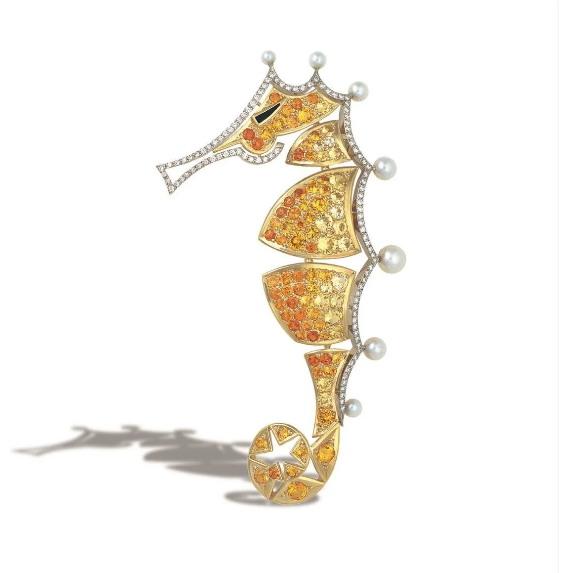A decorative seahorse brooch with gold, orange and yellow gemstones, pearls, and diamonds.