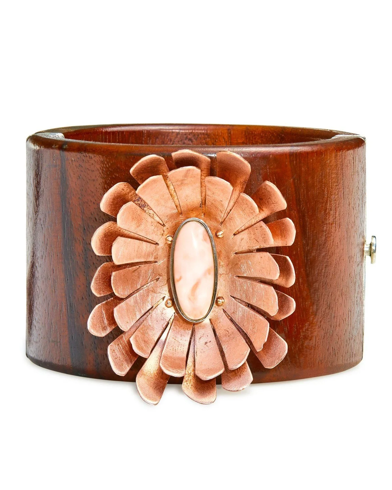Close-up of a wooden cuff bracelet with a large, oval, peach-colored stone and a flower-shaped metal ornament with petal details.
