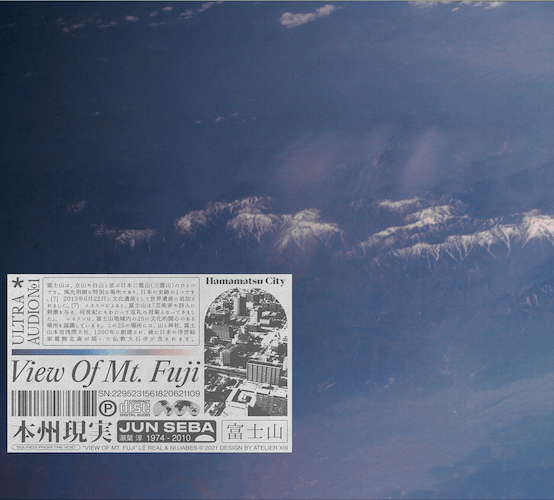 A clear sky with snow-capped mountains in the background and a promotional flyer for Mount Fuji in the foreground.