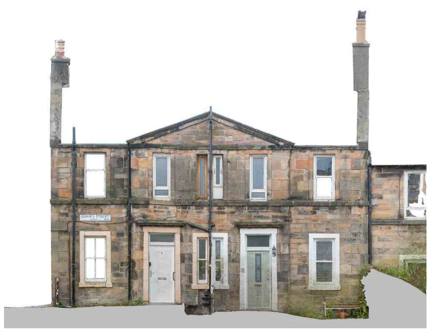 A multi-story stone building with multiple chimneys, windows, and doors, located on Shaw's Street.