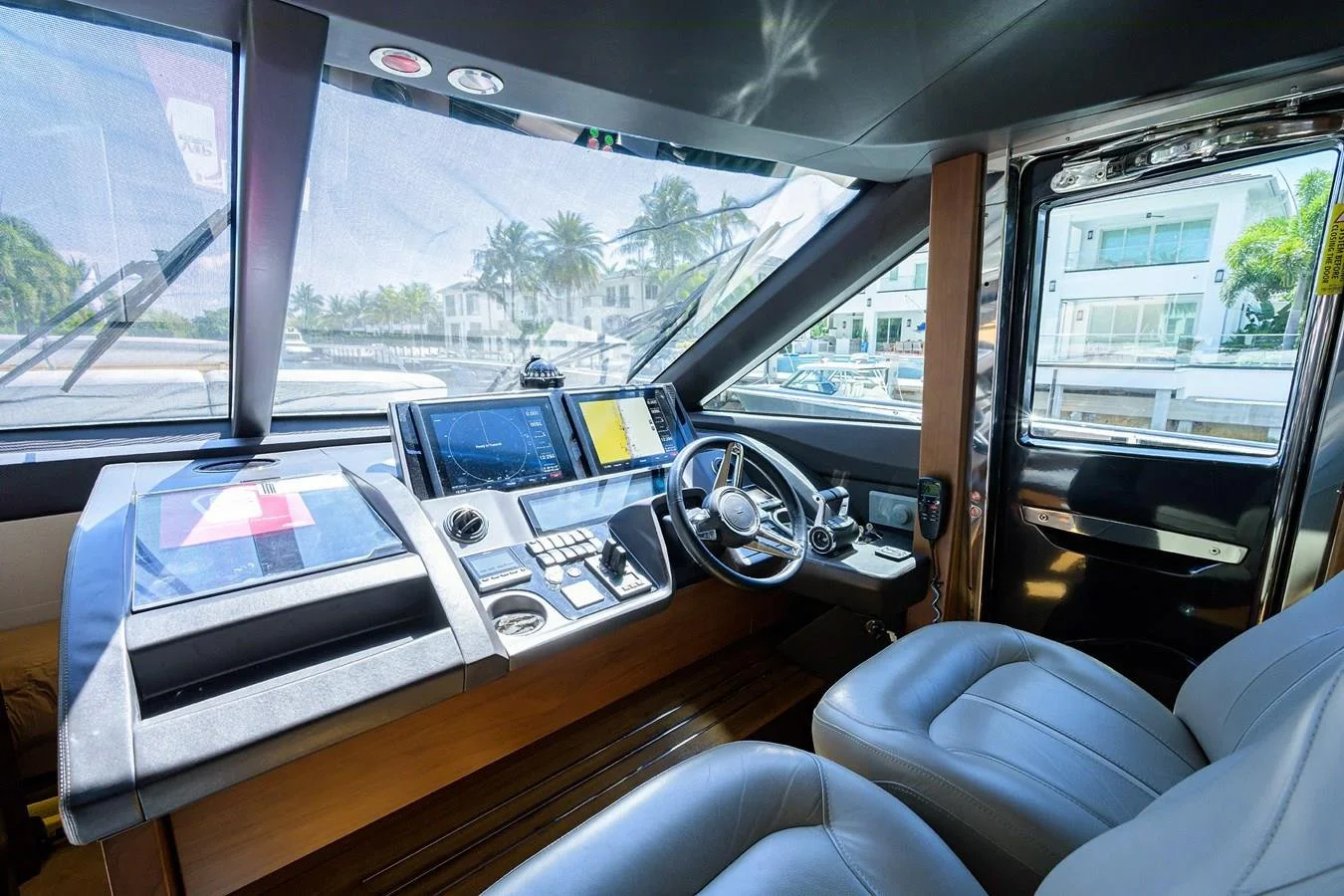 Captain’s helm and navigation console aboard Paulasea, a Princess 68 Flybridge yacht offering private charter experiences in Palm Beach, Florida.